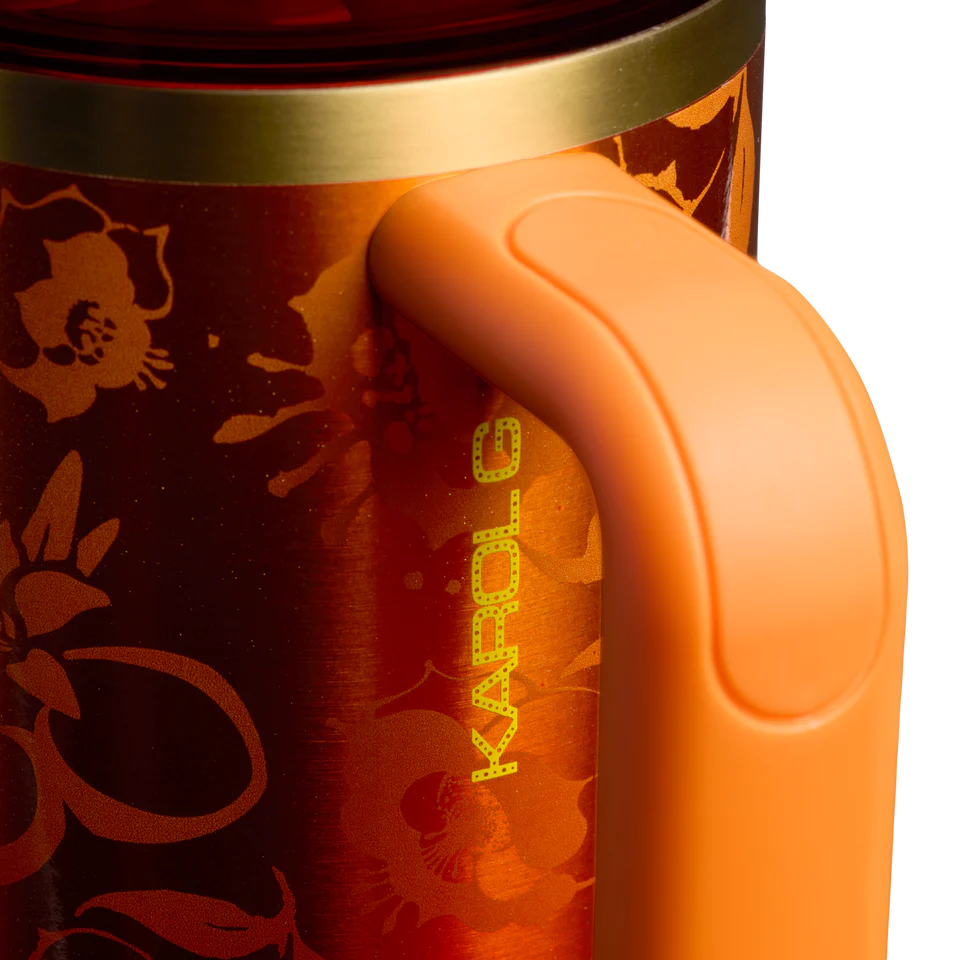 Stanley x Karol G 40 oz Quencher Tumbler in ruby red with floral artwork and pineapple straw topper next to its orange collector box - View 5 | Clistos