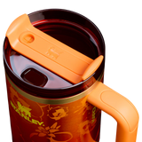 Stanley x Karol G 40 oz Quencher Tumbler in ruby red with floral artwork and pineapple straw topper next to its orange collector box - View 4 | Clistos