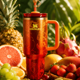 Stanley x Karol G 40 oz Quencher Tumbler in ruby red with floral artwork and pineapple straw topper next to its orange collector box - View 10 | Clistos