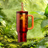 Stanley x Karol G 40 oz Quencher Tumbler in ruby red with floral artwork and pineapple straw topper next to its orange collector box - View 2 | Clistos